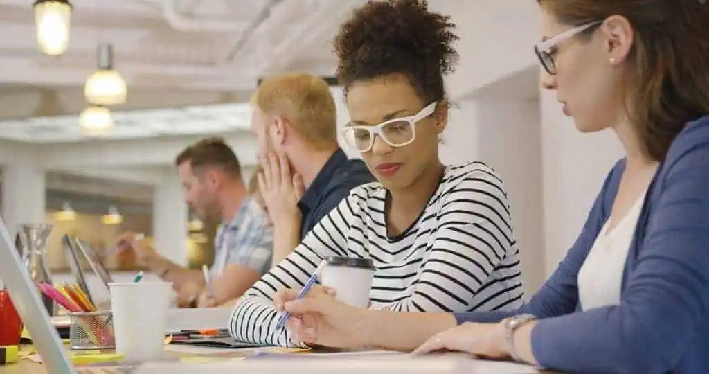 Employees working in team at table