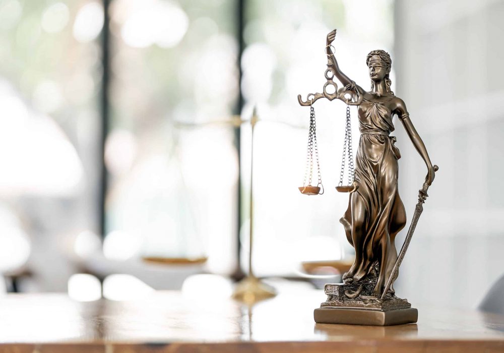Legal and law concept. Statue of Lady Justice with scales of justice on wooden table. Panoramic image statue of lady justice.